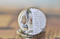 Close-up of the Alice in Wonderland illustration and book page design on the pocket watch pendant