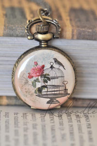Bronze pocket watch necklace with birdcage, rose and bird illustration on the front cover