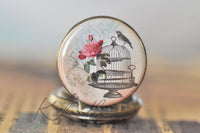 Close-up of the birdcage, rose and bird design on the pocket watch pendant
