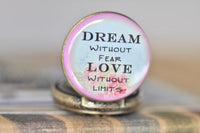 Close-up of pocket watch pendant quote face with pink floral border detail