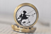 Pocket watch necklace standing upright showing silhouette girl flying a kite design