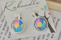 Round floral dangle earrings with pink, blue and yellow print on silver lever backs, displayed on Kaboodle card