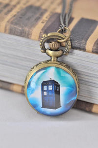 Bronze pocket watch necklace with a blue police box design on the front cover