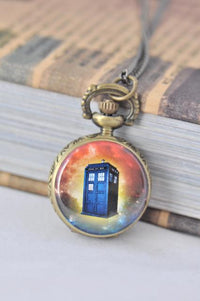 Bronze pocket watch necklace with a blue police box design set against a galaxy background