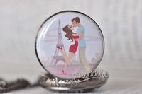 Close-up of Paris romance illustration on pocket watch pendant with Eiffel Tower background