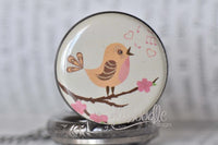Close up of singing bird illustration on pocket watch pendant lid