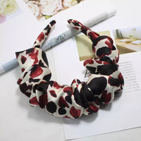 Ruffled headband shown from above resting on an open book