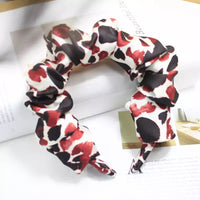 Ruffled fabric headband in red, black and cream abstract print, top-down view