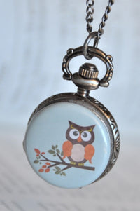 Owl on a branch pocket watch necklace hanging closed, bronze case with engraved edge