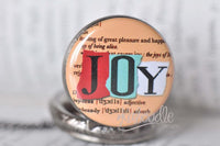 Close-up of the JOY dictionary definition design on the pocket watch lid