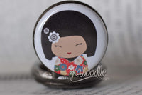 Front view of kawaii doll pocket watch pendant showing floral kimono and hair clip detail