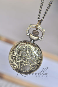 Antique bronze pocket watch case back with embossed sunflower and vine pattern
