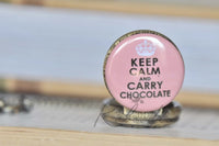 Close-up of pink Keep Calm and Carry Chocolate pocket watch pendant design