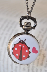Ladybird pocket watch necklace with polka-dot beetle and pink heart design on front cover