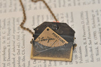 Bronze-tone envelope pendant open to show 'I Love You' postcard tucked inside