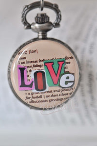 Close-up of Love dictionary pocket watch necklace pendant with colourful lettering