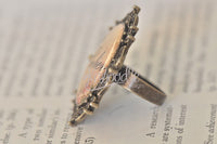 Side profile of the Love cameo ring showing raised resin dome and adjustable bronze band