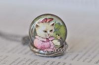 Close-up of the kitten in pink illustration on the pocket watch pendant