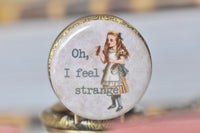 Detail of Alice holding the Drink Me bottle on the pocket watch pendant face