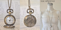 Open pocket watch necklace showing the Quartz watch face, embossed floral back cover and size reference on a mannequin