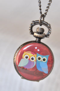 Owl lovers pocket watch necklace with two cartoon owls on a red heart background