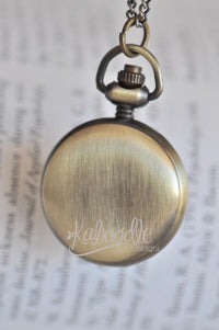 Back view of antique bronze pocket watch pendant showing brushed metal case