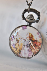 Purple fairy pocket watch necklace featuring a fairy reaching for bellflowers, in antique bronze case