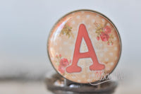 Close-up of shabby chic pink rose initial pendant with letter A design