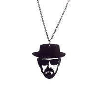 Front view of black acrylic silhouette pendant on gunmetal chain against white background