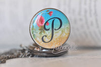 Close-up of rose initial P pocket watch pendant lid design detached from chain