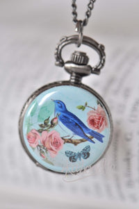 Victorian bird pocket watch necklace with pink roses on pale turquoise background